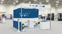 Simple modular trade show booth with blue and white design, clean professional look, basic structure, minimal furniture, open layout.webp
